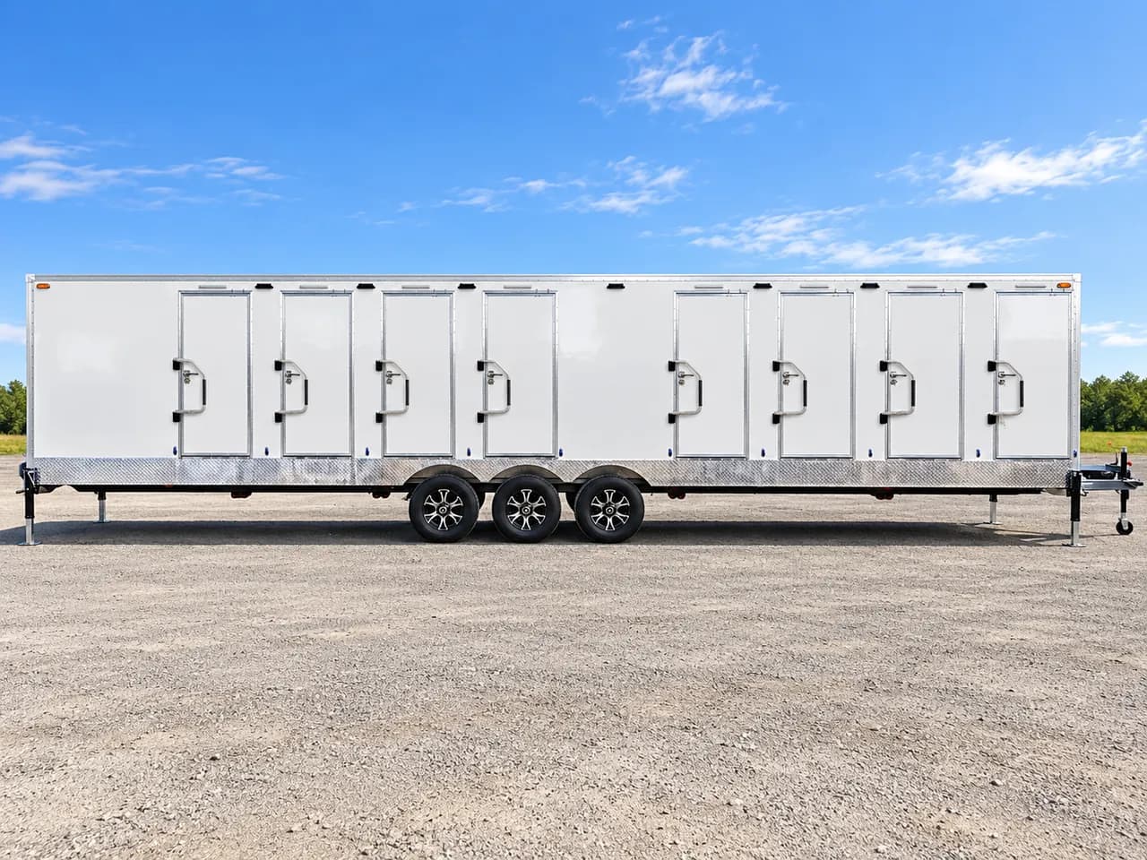 Side view of a shower and restroom combination trailer with separate entrances