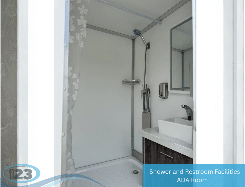 Accessible shower and restroom trailer interior with handheld shower, sink, mirror, and ADA-compliant layout