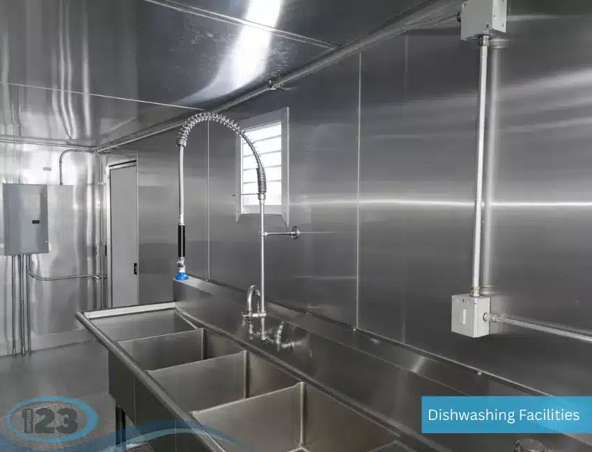 Dishwashing trailer featuring professional cleaning, rinsing, and sanitizing stations for food service applications.