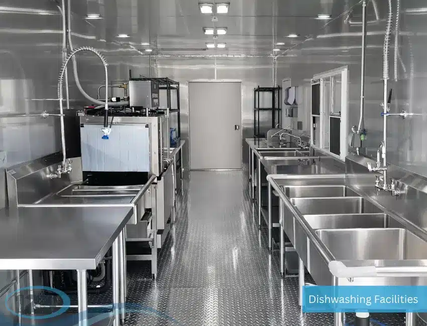 Mobile dishwashing trailer featuring commercial cleaning stations with stainless steel sinks and food service sanitation equipment.