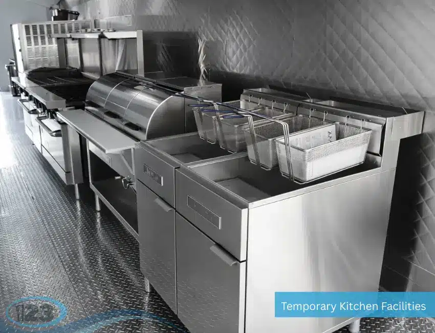 Industrial mobile kitchen featuring a triple sink system, stainless steel surfaces, and health-compliant food service equipment.