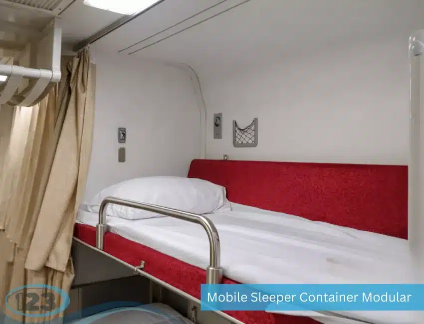 Compact mobile sleeper container cabin with a single bunk bed, privacy curtain, pillow, reading light, and built-in storage designed for workforce lodging and temporary housing.